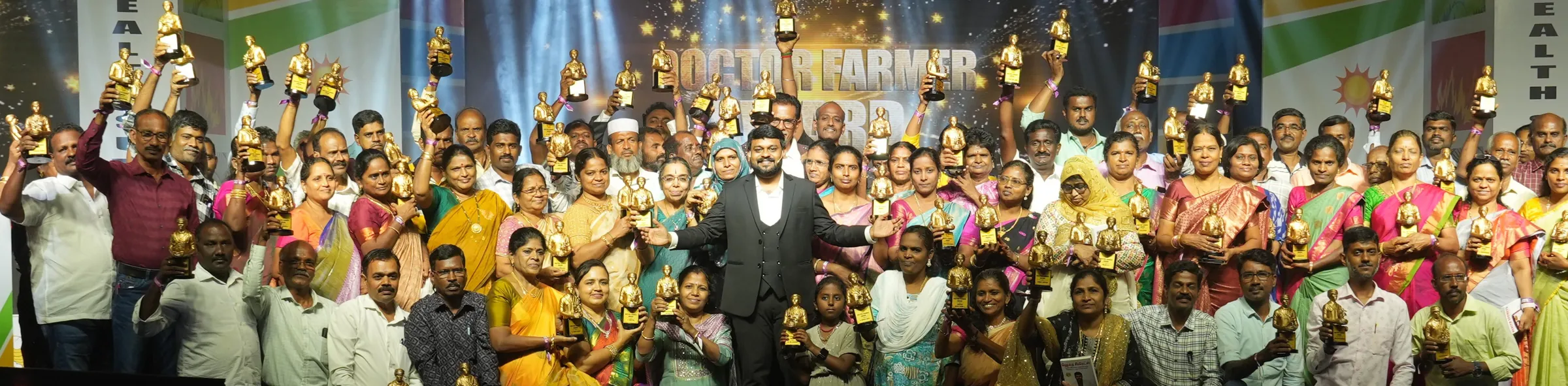 Doctor Farmer with award-winning clients on stage